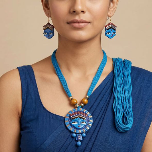 Woman wearing a blue necklace and earrings with intricate designs on a beige background