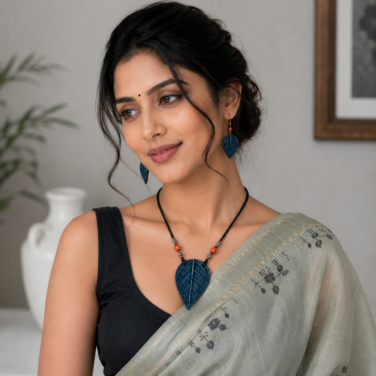 Woman wearing a necklace and earrings with a neutral background